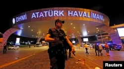 FILE - A police officer stands guard at the entrance of the Ataturk airport in Istanbul, Turkey, June 29, 2016.