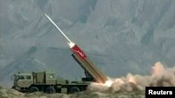 FILE - This still image from a Pakistan military handout video shows a NASR (Hatf IX) missile being fired during a test at an undisclosed location in Pakistan, April 19, 2011.