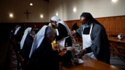 Benedictine Sisters serve "Maredret" beer, with ingredients inspired by the monastery garden, in Anhee, Belgium, Dec. 8, 2021.