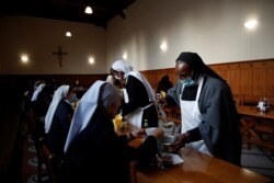 Benedictine Sisters serve "Maredret" beer, with ingredients inspired by the monastery garden, in Anhee, Belgium, Dec. 8, 2021.