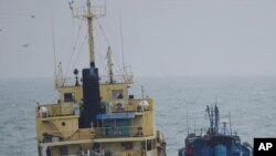 FILE - This photo released by Japan's Ministry of Defense shows what it says is the North Korean-flagged tanker Yu Jong 2, left, and Min Ning De You 078 lying alongside in the East China Sea, Feb. 16, 2018. 