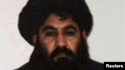 FILE- Mullah Akhtar Mohammad Mansour, Taliban militants' leader, is seen in this undated handout photograph by the Taliban. After days of widespread reports that he had been seriously wounded in a gunfight with rival militant commanders, the Islamist insurgency released a voice message from its chief to prove he is alive.