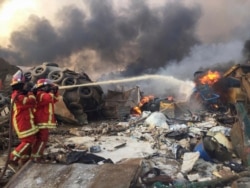 Firefighters spray water at a fire after an explosion was heard in Beirut, Lebanon August 4, 2020.