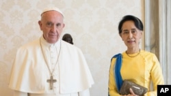 FILE - State Counsellor and Union Minister for Foreign Affairs of the Republic of the Union of Myanmar Aung San Suu Kyi poses with Pope Francis on the occasion of their private audience, at the Vatican, May 4, 2017.
