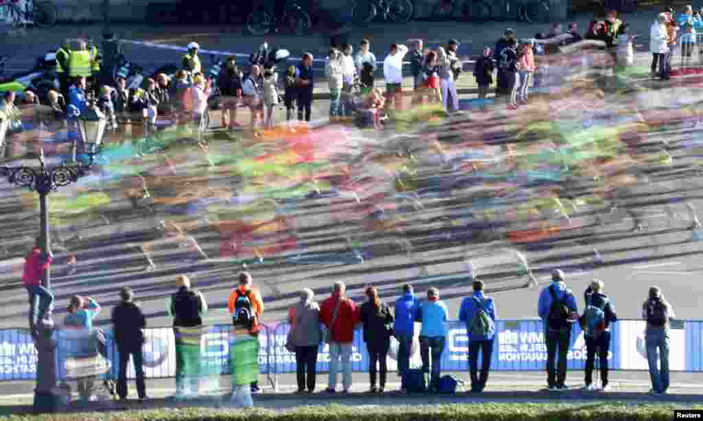 Spectators watch as runners compete in the 42nd Berlin marathon, in Berlin, Germany.