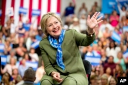 Democratic presidential candidate Hillary Clinton waves to members of the audience as she arrives at a rally at Adams City High School in Commerce City, Colorado, Aug. 3, 2016.