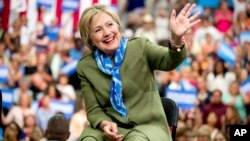 Democratic presidential candidate Hillary Clinton waves to members of the audience as she arrives at a rally at Adams City High School in Commerce City, Colorado, Aug. 3, 2016.