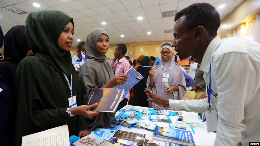 FILE - People browse through books during the third annual book fair in Mogadishu, Somalia, Sept. 14, 2017. 