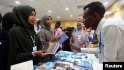 FILE - People browse through books during the third annual book fair in Mogadishu, Somalia, Sept. 14, 2017. 