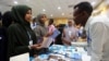 FILE - People browse through books during the third annual book fair in Mogadishu, Somalia, Sept. 14, 2017. 