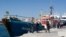 Italian police stand around the German NGO Jugend Rettet ship Iuventa in Lampedusa harbor, Italy, Aug. 2, 2017.
