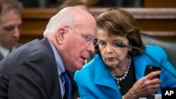 FILE - Democratic Sen. Patrick Leahy speaks with Sen. Dianne Feinstein during a meeting on Capitol Hill in Washington, March 10, 2016. Along with Senator Benjamin Cardin, Leahy and Feinstein on Monday called for the establishment of an independent panel to investigate allegations of Russia's meddling in the U.S. election.