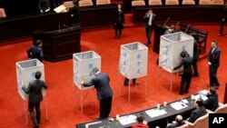 Legislature officers prepare voting booths to elect a new speaker on the legislature floor in Taipei, Taiwan, Feb. 1, 2016. 