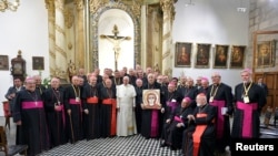 FILE - Pope Francis poses with bishops in the sacristy of the Cathedral of Santiago, in Santiago, Chile, Jan. 16, 2018. 