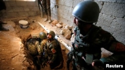 Peshmerga forces inspect a tunnel used by Islamic State militants in the town of Bashiqa, after it was recaptured from the Islamic State, east of Mosul, Iraq, Nov. 12, 2016. 