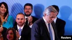 Argentina's incoming Economy Minister Martin Guzman watches Argentina's President-elect Alberto Fernandez before he announces his cabinet, ahead of taking office on Dec. 10, in Buenos Aires, Argentina, Dec. 6, 2019. 