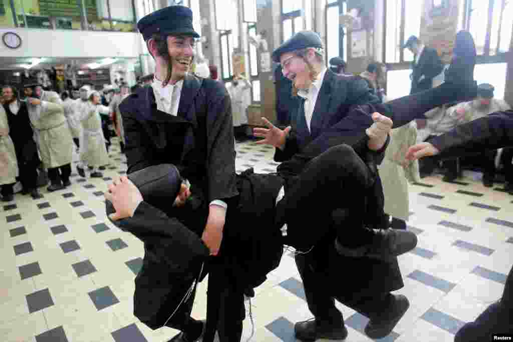 Ultra-Orthodox Jewish youths celebrate during an annual parade marking the Jewish holiday of Purim, in Jerusalem.