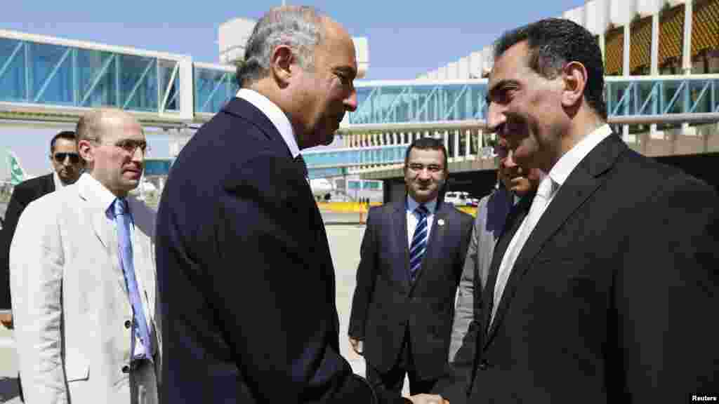 Iraq's Deputy Foreign Minister Nizar al-Khairallah, right, welcomes French Foreign Affairs Minister Laurent Fabius upon his arrival to Baghdad's airport in Baghdad, Aug. 10, 2014.