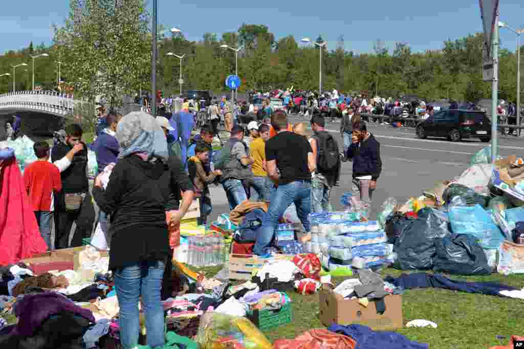 Refugees are being supplied with food and water as they wait at the border between Austria and Germany in Salzburg.