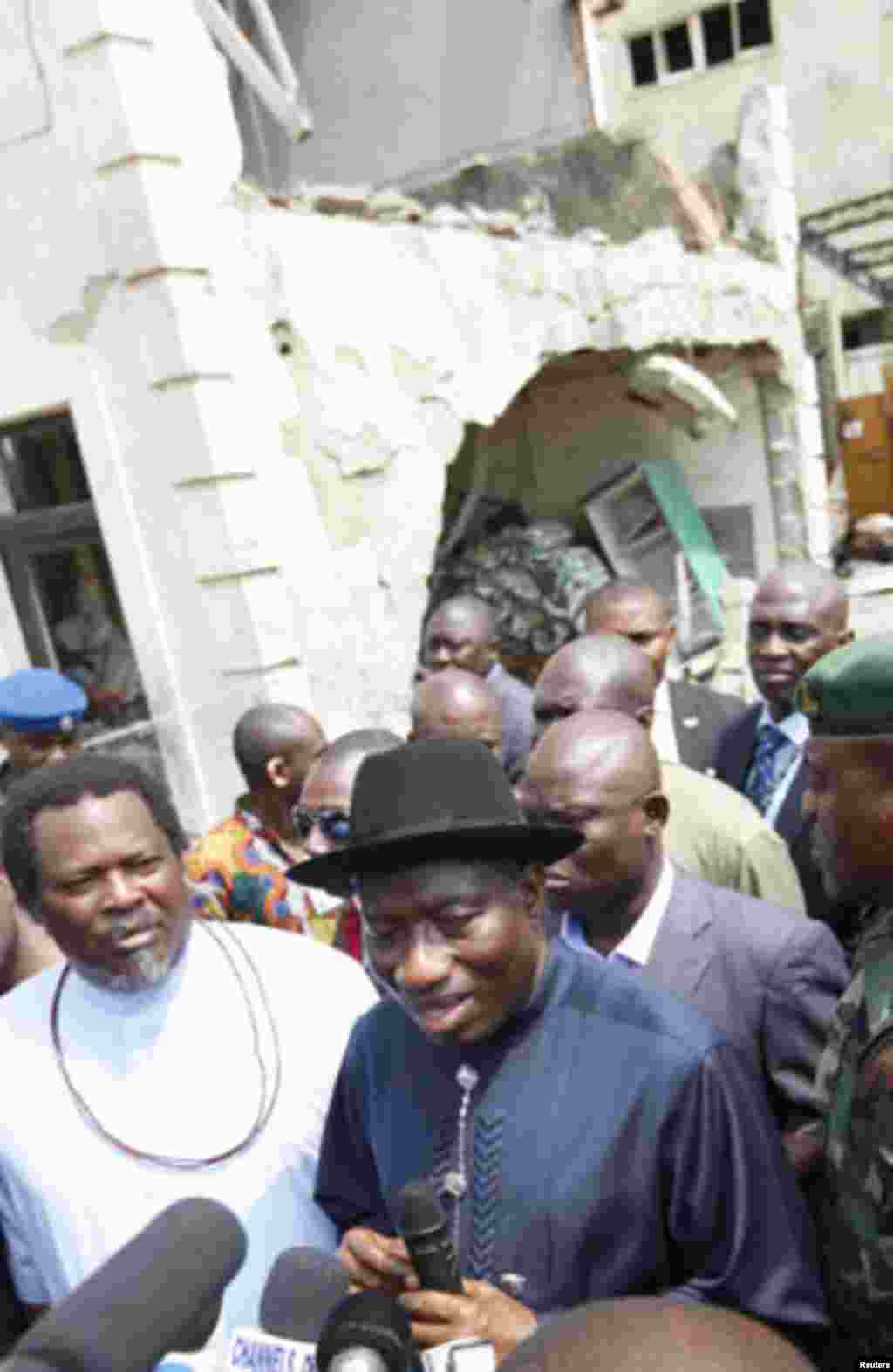 Nigeria's President Goodluck Jonathan (R) stands with This Day's publisher Nduka Obaigbena during a visit to This Day newspaper in Abuja April 28, 2012. Suicide car bombers targeted the offices of Nigerian newspaper This Day in the capital Abuja and north