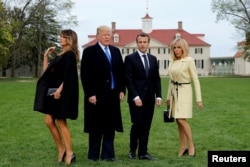 U.S. President Donald Trump and first lady Melania Trump and French President Emmanuel Macron and Brigitte Macron prepare to have their picture taken on a visit to the estate of the first U.S. President George Washington in Mount Vernon, Virginia.