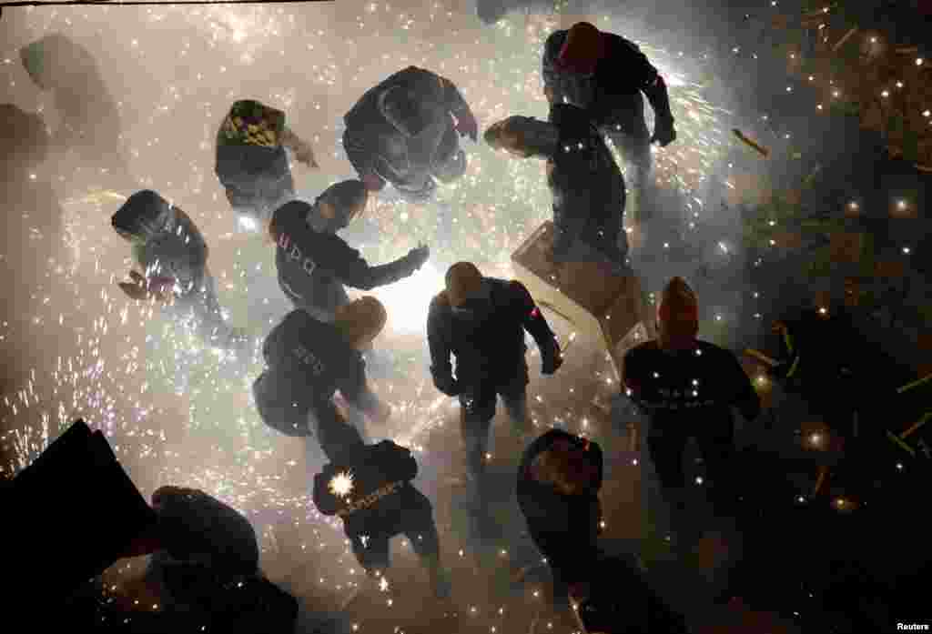 Revelers play with fireworks during the annual &quot;Corda&quot; festival in the village of Paterna near Valencia, Spain.