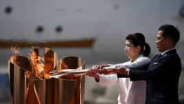 A scene from the torch relay earlier in 2021. People typically wonder who will light the cauldron in the Olympic stadium. (Photo by Philip FONG / AFP)