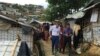 International Committee of the Red Cross President Peter Maurer, foreground and left, visits a Rohingya refugee camp in Cox's Bazar, Bangladesh, July 1, 2018.