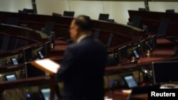 FILE - Empty seats of pro-democracy legislators are seen in the background during debate on an electoral reform bill at the Legislative Council in Hong Kong, May 26, 2021.