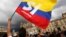 FILE - A supporter of the peace deal between the Colombian government and rebels of the Revolutionary Armed Forces of Colombia waves a flag during a rally in front of Congress, in Bogota, Colombia, Oct. 3, 2016. After Colombians rejected the deal, both sides are returning to talks in Cuba.