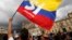 FILE - A supporter of the peace deal between the Colombian government and rebels of the Revolutionary Armed Forces of Colombia waves a flag during a rally in front of Congress, in Bogota, Colombia, Oct. 3, 2016.