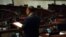 FILE - Empty seats of pro-democracy legislators are seen in the background during debate on an electoral reform bill at the Legislative Council in Hong Kong, May 26, 2021.