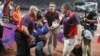 A man, identified by police as Ashley Gill-Webb, 34, is detained by security after a bottle was thrown onto the track just before the men's 100-meter final at the London 2012 Olympic Games in London, August 5, 2012. 