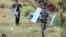 Lebanese soldiers carry parts of an Israeli MK drone that fell in South Lebanon's Marjeyoun countryside near the border with Israel. Israeli media said the IDF confirmed the drone was from Israel.