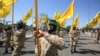 FILE - Iraqi Shiite fighters from the Nujaba armed group march during a military parade marking Al-Quds (Jerusalem) International Day in Baghdad, May 31, 2019.