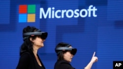 FILE - Members of a design team demonstrate the use of Microsoft's HoloLens device at a developers conference in Seattle, Washington, May 11, 2017. Microsoft says it has won a major contract to supply the U.S. Army with its virtual reality headsets. 