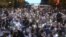 Protesters take a knee on Flatbush Avenue in front of New York City police officers during a solidarity rally for George Floyd, June 4, 2020, in the Brooklyn borough of New York. 