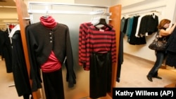 A woman looks through clothing at Lord & Taylor department store in New York City. (AP Photo/Kathy Willens)