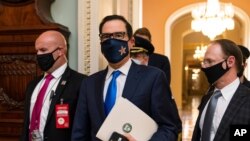 Treasury Secretary Steven Mnuchin makes a brief comment as he leaves the Capitol, Sept. 30, 2020, in Washington. Mnuchin earlier met with House Speaker Nancy Pelosi of California.