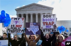 Pro-abortion rights protesters rally outside the Supreme Court in Washington, March 2, 2016.