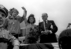 FILE - Jacqueline Gareau of Montreal has her hand held high by runner Bill Rodgers on May 14, 1980, in Boston, three weeks and two days after the Boston Marathon.