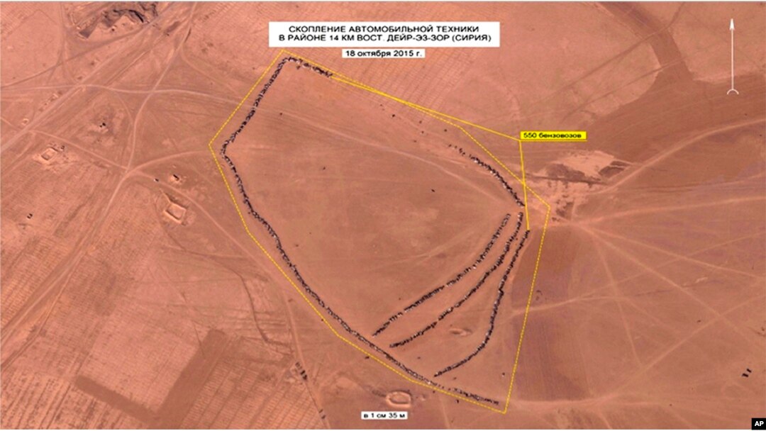 In this photo made from video taken from Russian Defense Ministry official web site on Oct. 1, 2015, an aerial image of what they purport shows lines of oil trucks 14 km (8.8 miles) east of Dayr-az-Zawr, Syria.