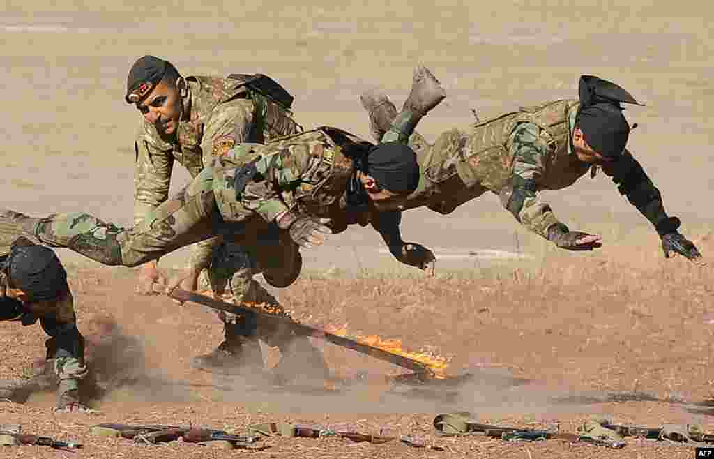 Armenian military scouts demonstrate their skill during a performance to mark the annual anniversary of the Armenian Armed Forces reconnaissance troops formation, some 25 km outside in Yerevan.