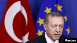 FILE - Turkey's President Tayyip Erdogan at the European Union Commission headquarters in Brussels, Belgium. The EU noted Turkey's continued interest in joining the bloc, but said that was offset by some key legislation that "ran against European standards."