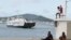 FILE - A boat arrives at Dzaoudzi on the Indian Ocean island of Mayotte, March 31, 2012. The Somali government said, Nov. 25, 2024, it will begin evacuating the survivors of two boats, carrying mostly Somali migrants, which capsized off the coast of Madagascar on Nov. 23.