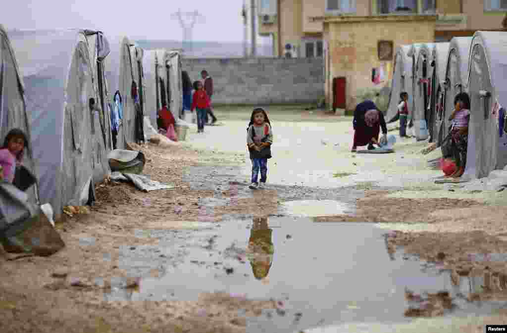 A child from the Syrian town of Kobani walks in a refugee camp in the southeastern town of Suruc, Oct. 16, 2014.
