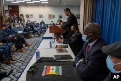 Mahamud Ugas, center, speaks during a signing ceremony of the United Front of Ethiopian Federalist and Confederalist Forces to establish a grand United Front to against the government of Prime Minister Abiy Ahmed, in Washington, Nov. 5, 2021.