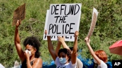 Na demonstracijama u Fenixu, Arizoni, transparent koji traži da se ukine budžet policiji 