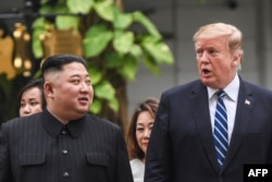 FILE - US President Donald Trump (R) walks with North Korea's leader Kim Jong Un during a break in talks at the second US-North Korea summit at the Sofitel Legend Metropole hotel in Hanoi on Feb. 28, 2019.