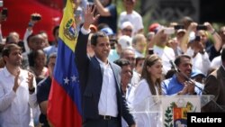 Venezuelan opposition leader and self-proclaimed interim president Juan Guaido waves to supporters during a rally against Venezuelan President Nicolas Maduro's government, in Caracas, Venezuela, Feb. 2, 2019.